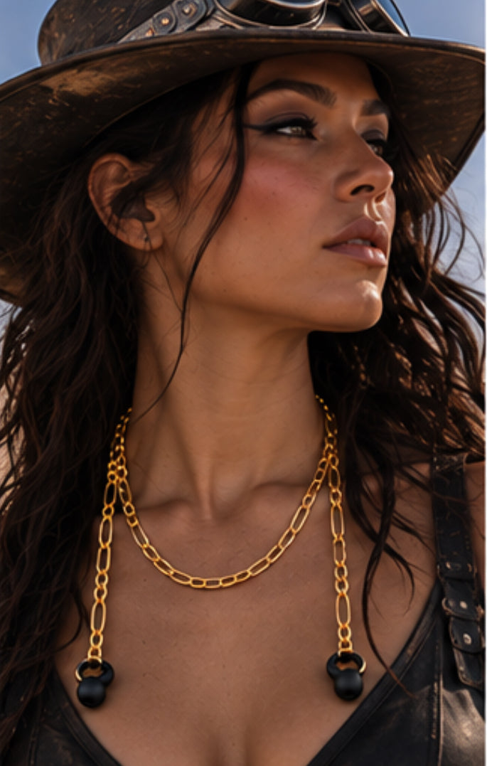 The gold ARKS chain laid out at full length, an earplug on each drop strand.